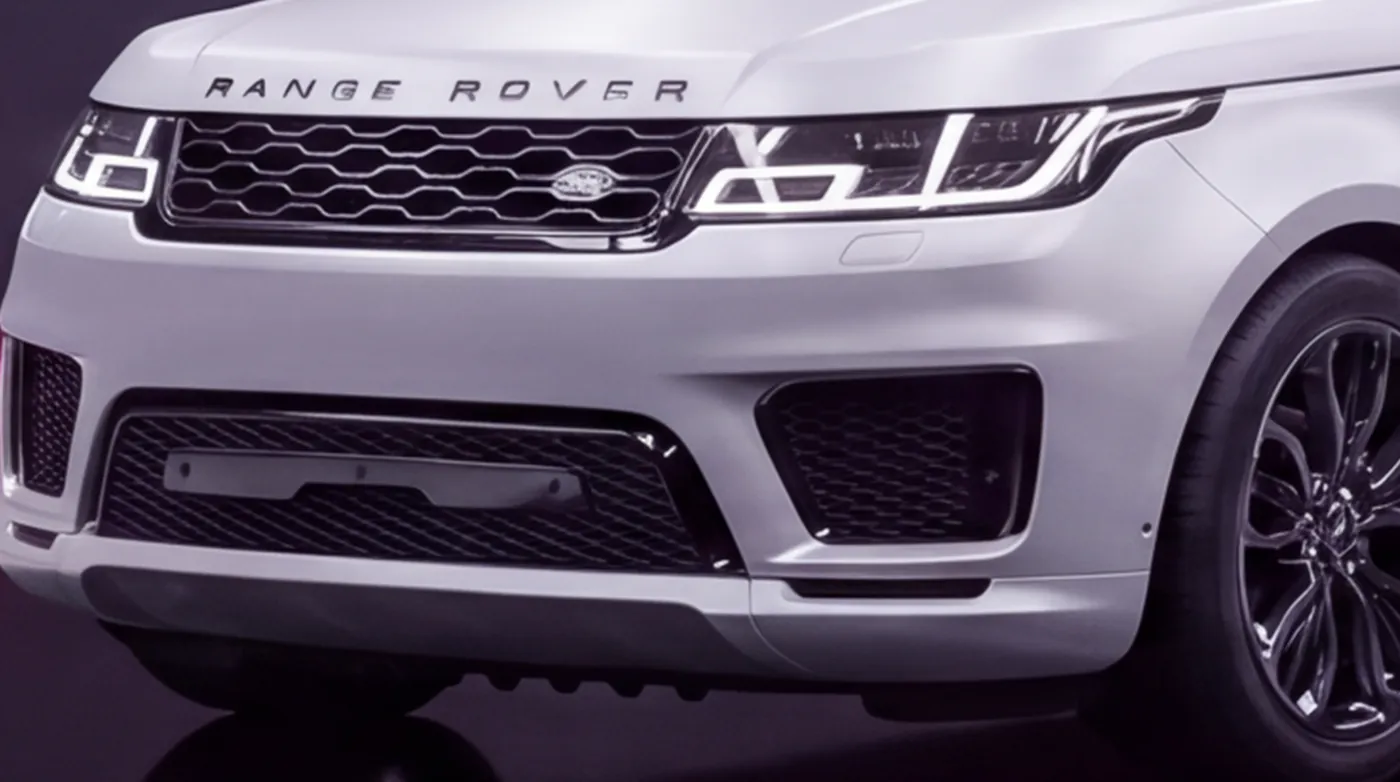 Close-up of the Range Rover Sport's grille and bumper wrapped in gloss black